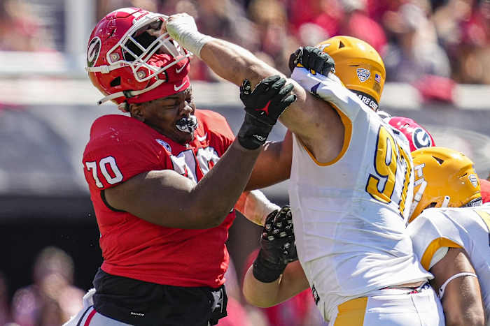 Sep 24, 2022; Athens, Georgia, USA; Georgia Bulldogs offensive lineman Warren McClendon (70) loses his helmet to Kent State Golden Flashes defensive lineman Oliver Billotte (97) at Sanford Stadium. Mandatory Credit: Dale Zanine-USA TODAY Sports